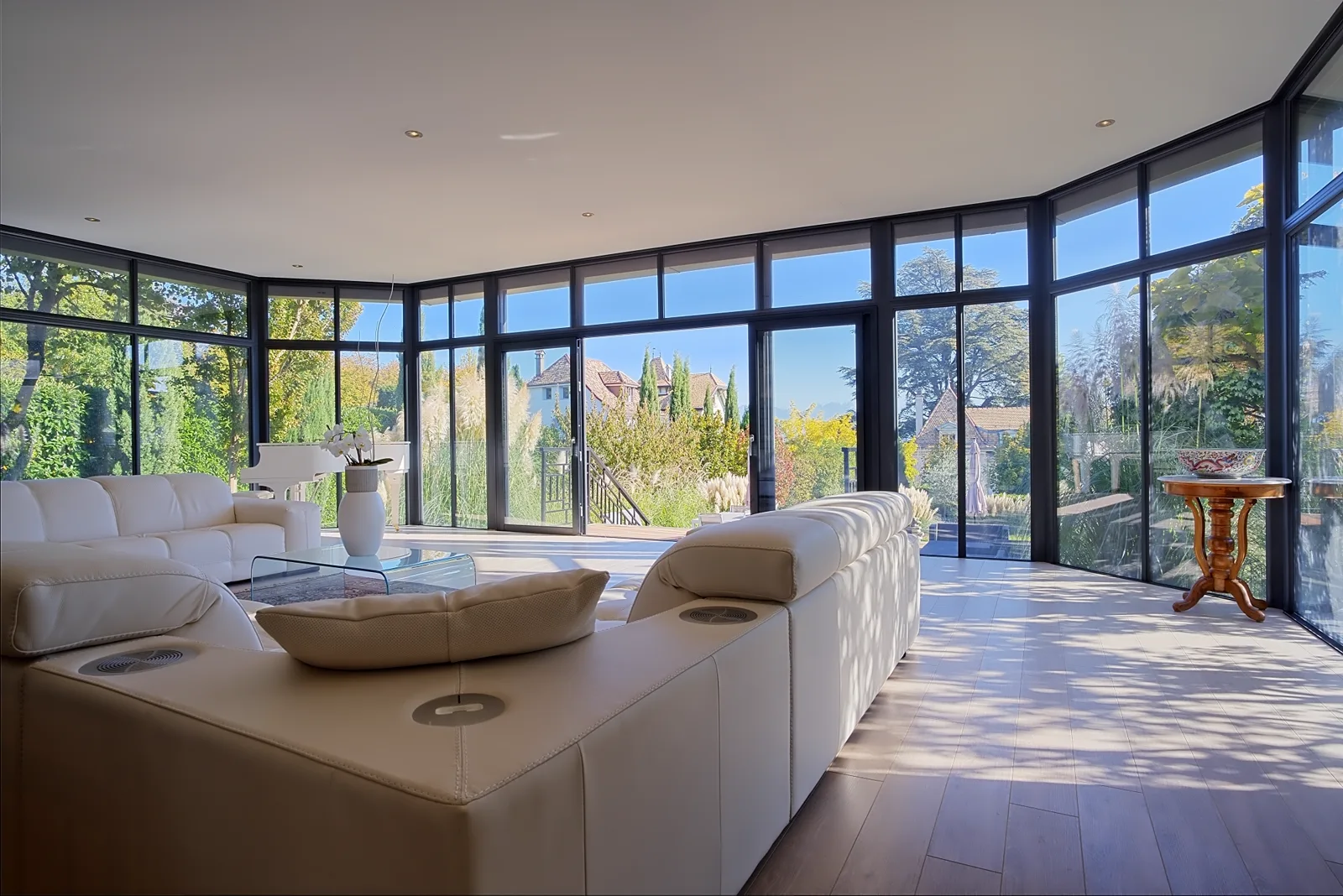 Light-filled glazed living room opening onto the grounds